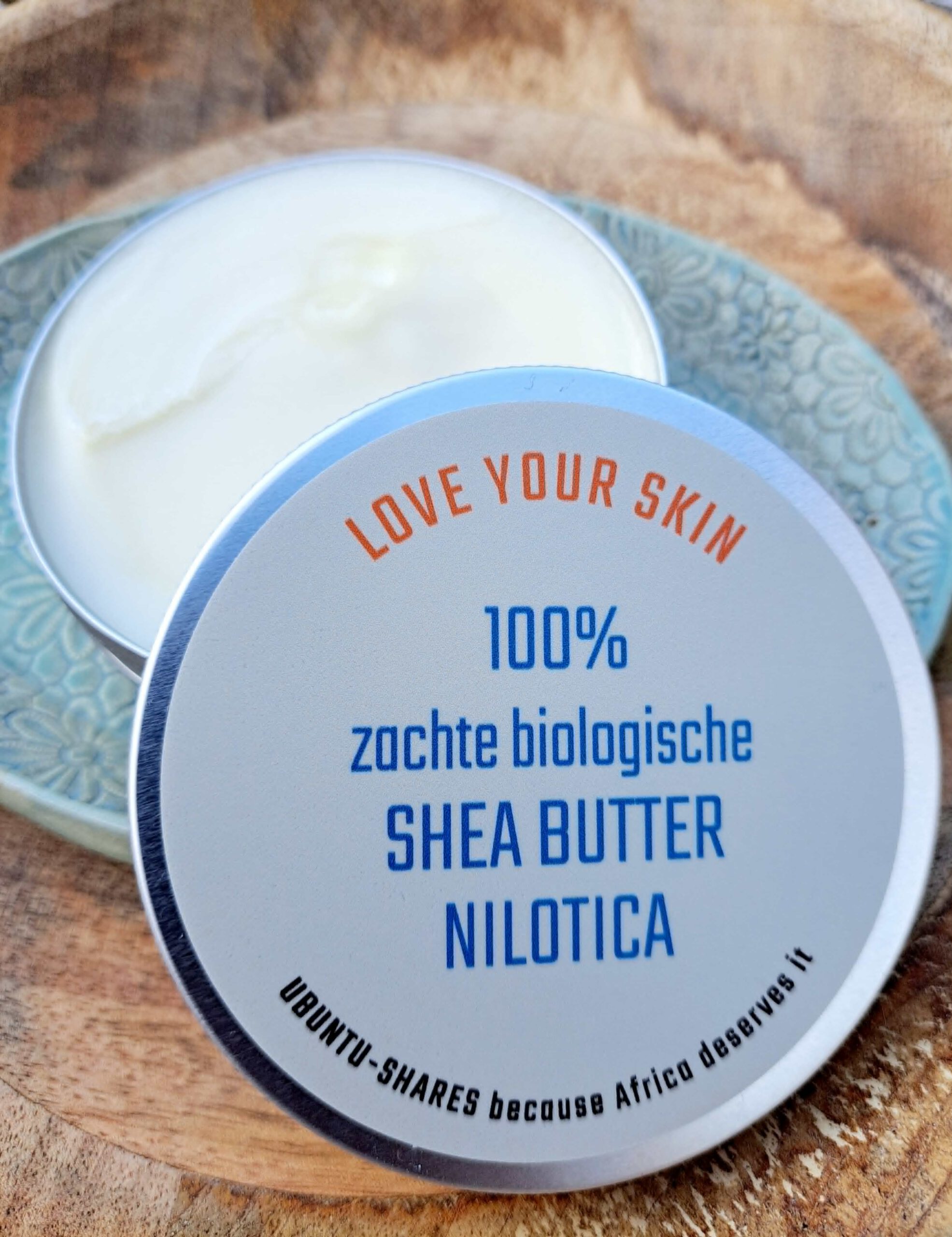 a jar of body butter on a plate